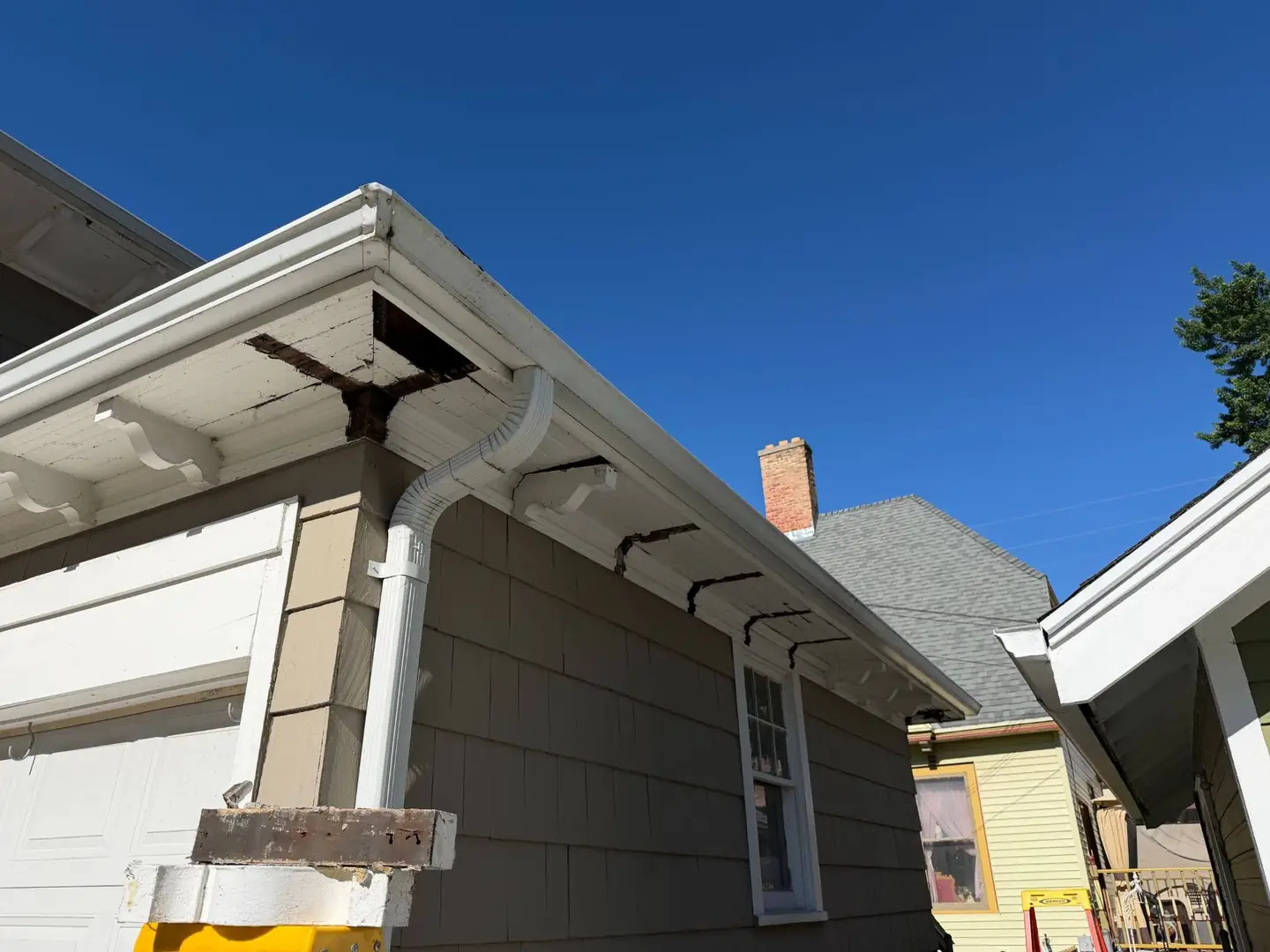 Mid-repair, with the gutter down and the damaged section out.