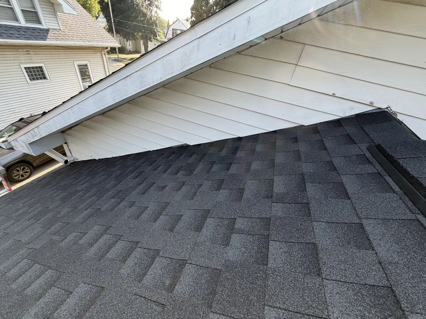 Where the garage roof ties into the house wall, the joint that leaks first if it is flashed badly.